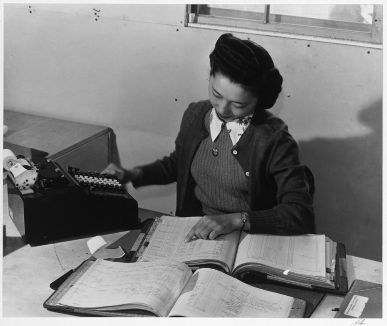 Photograph of a woman reviewing accounting books