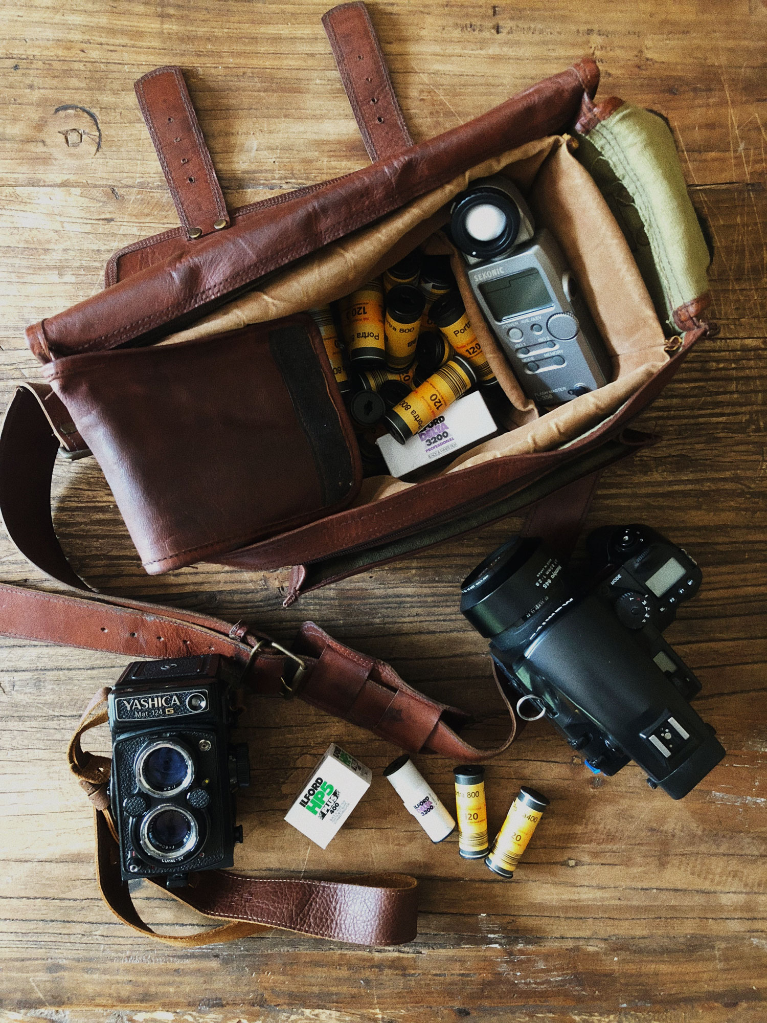 Open Camera Bag, Cameras, and Rolls of Film